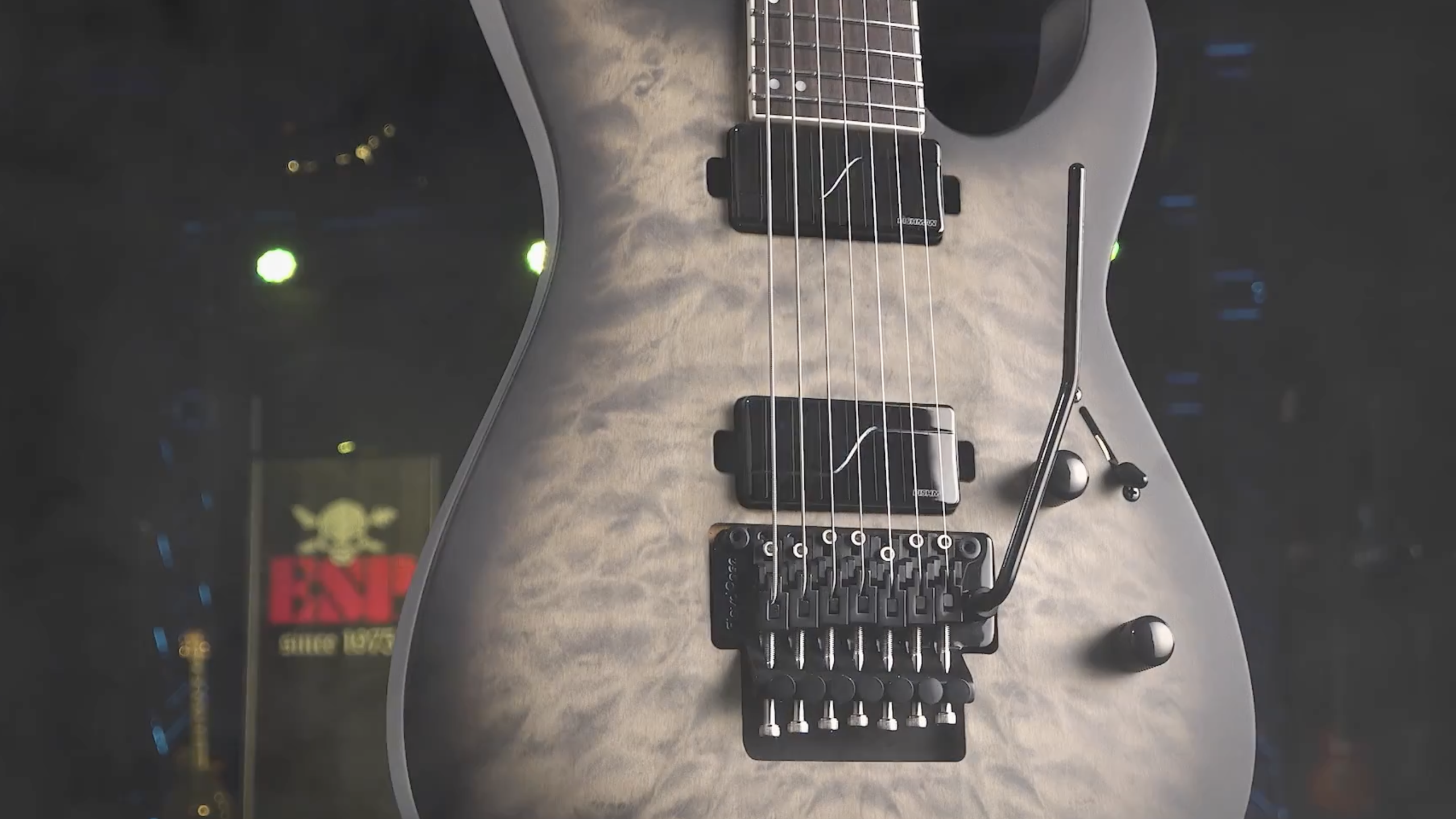 ESP LTD M-1007B 7-string baritone electric guitar in Charcoal Burst Satin with quilted top and Floyd Rose tremolo.