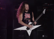 Musician playing an ESP LTD Deluxe RS-1000 white offset electric guitar in front of ENGL amplifier stacks.