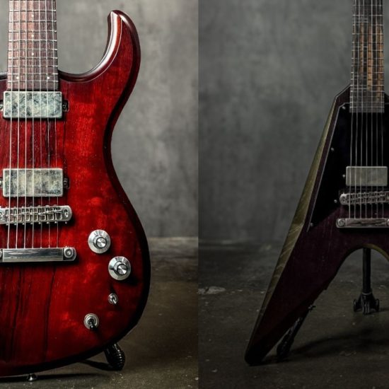 Two Dunable production series 7-string electric guitars in deep red finish, one double-cut and one V-style body.