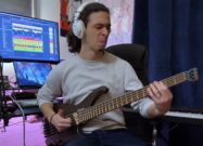 Riccardo Oliva playing an Ibanez EHB605 headless 5-string bass in a home studio setup.