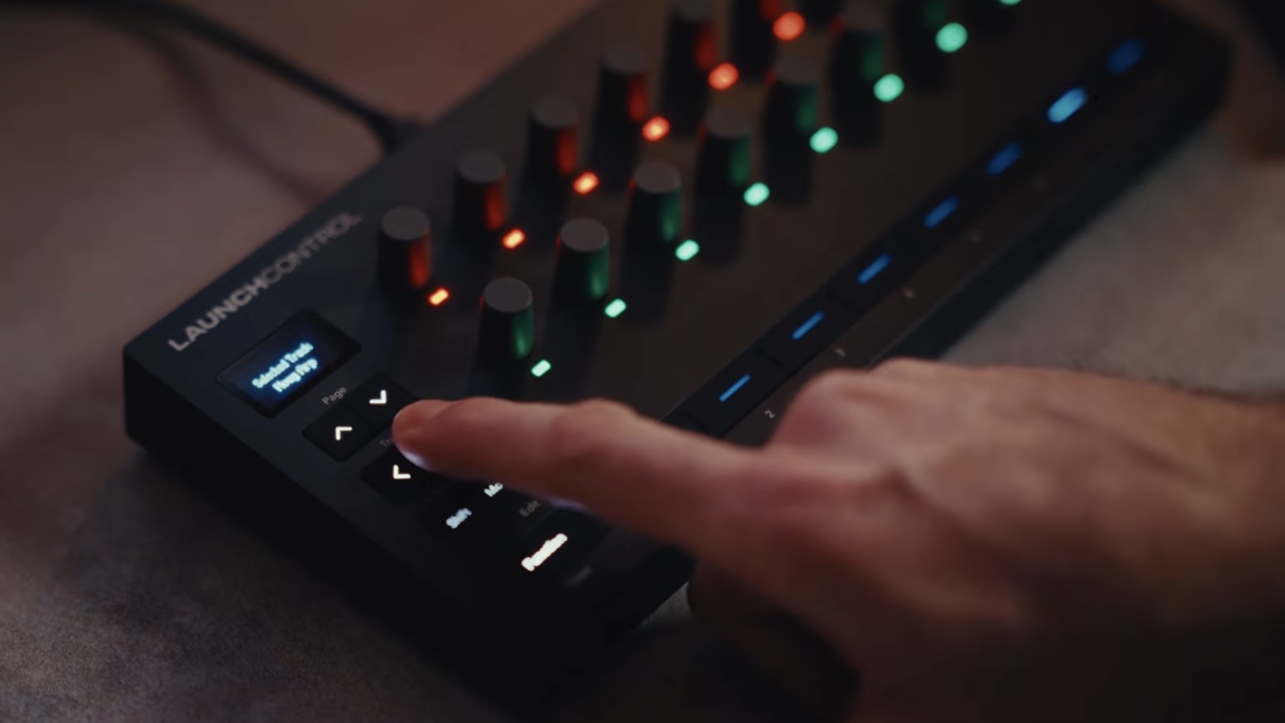 Novation Launch Control 3 compact MIDI controller with rotary encoders, LED indicators, and OLED display.