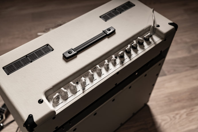 Top and angled side view of an EVH 5150III Hypersonic 6L6 2x12 combo amplifier in black and ivory finishes, showing detailed control knobs, input sections, and vented top panel.