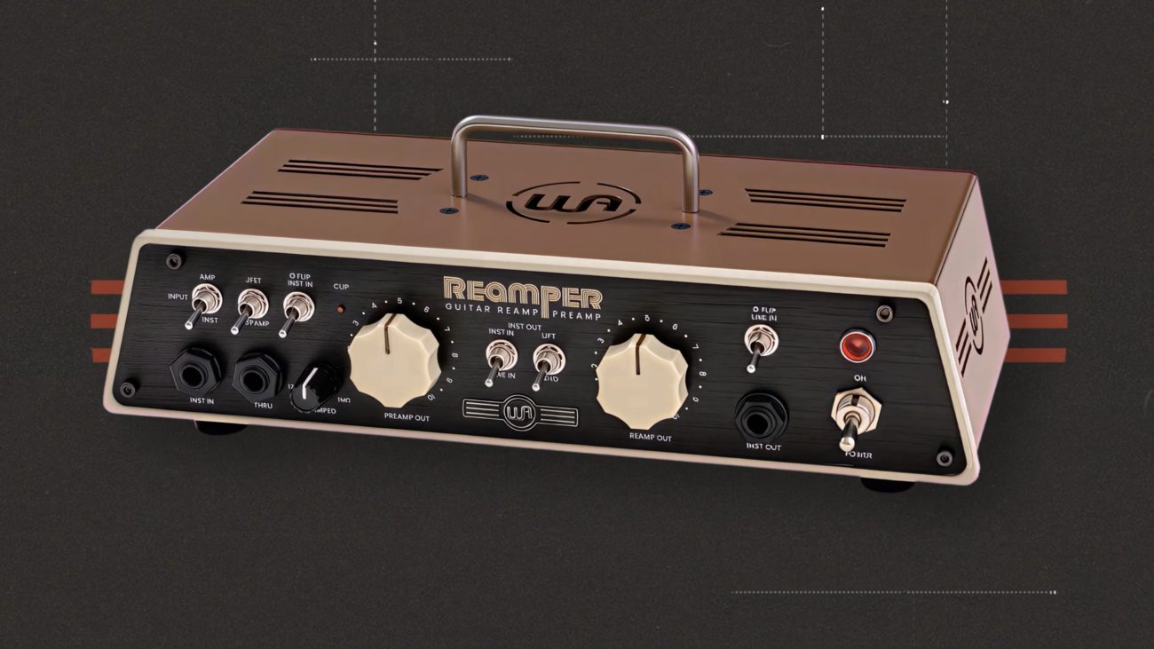 Front view of the Warm Audio Reamper guitar re-amping and routing unit with dual large knobs, multiple input and output jacks, toggle switches, and a built-in handle on a beige metal chassis.