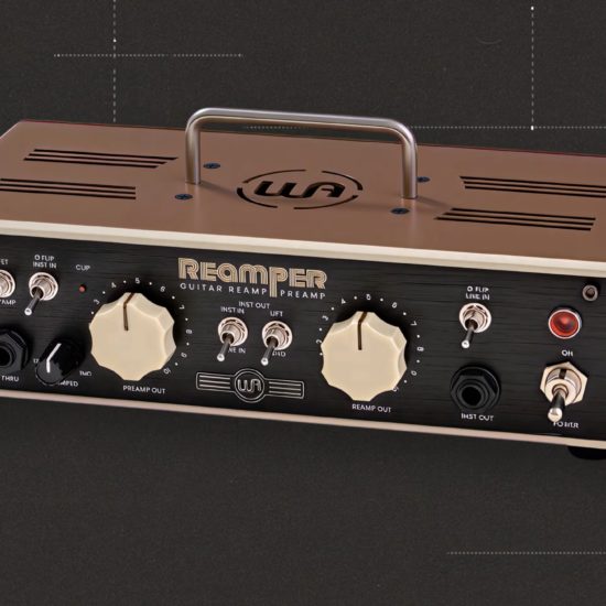 Front view of the Warm Audio Reamper guitar re-amping and routing unit with dual large knobs, multiple input and output jacks, toggle switches, and a built-in handle on a beige metal chassis.