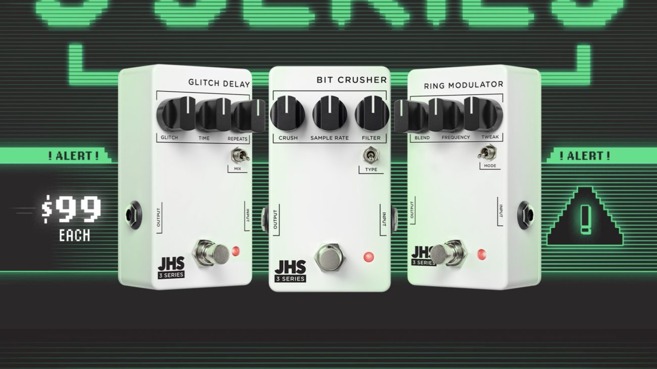 Three white JHS 3 Series guitar pedals — the Glitch Delay, Bit Crusher, and Ring Modulator — are displayed side by side against a retro green digital “ALERT!” background. Each pedal features minimalist black knobs, simple labeling, and a compact design, with a “$99 each” graphic shown on the left.