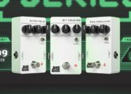Three white JHS 3 Series guitar pedals — the Glitch Delay, Bit Crusher, and Ring Modulator — are displayed side by side against a retro green digital “ALERT!” background. Each pedal features minimalist black knobs, simple labeling, and a compact design, with a “$99 each” graphic shown on the left.