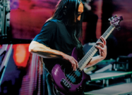 A photo of John Myung playing the John Myung Bongo 4