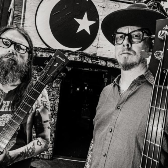 Photo of Monolord instrumentalists Thomas Jäger and Mika Hakki holding their new Dunable signature models