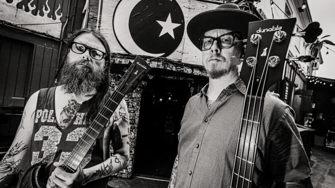 Photo of Monolord instrumentalists Thomas Jäger and Mika Hakki holding their new Dunable signature models
