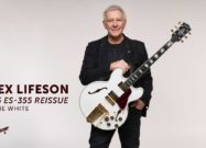 A photo of Rush guitarist Alex Lifeson holding the Epiphone IGC Alex Lifeson 1976 ES-355 Reissue