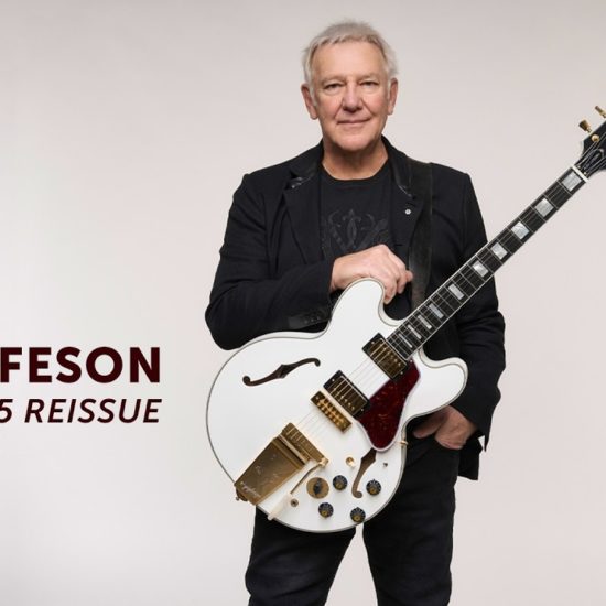 A photo of Rush guitarist Alex Lifeson holding the Epiphone IGC Alex Lifeson 1976 ES-355 Reissue