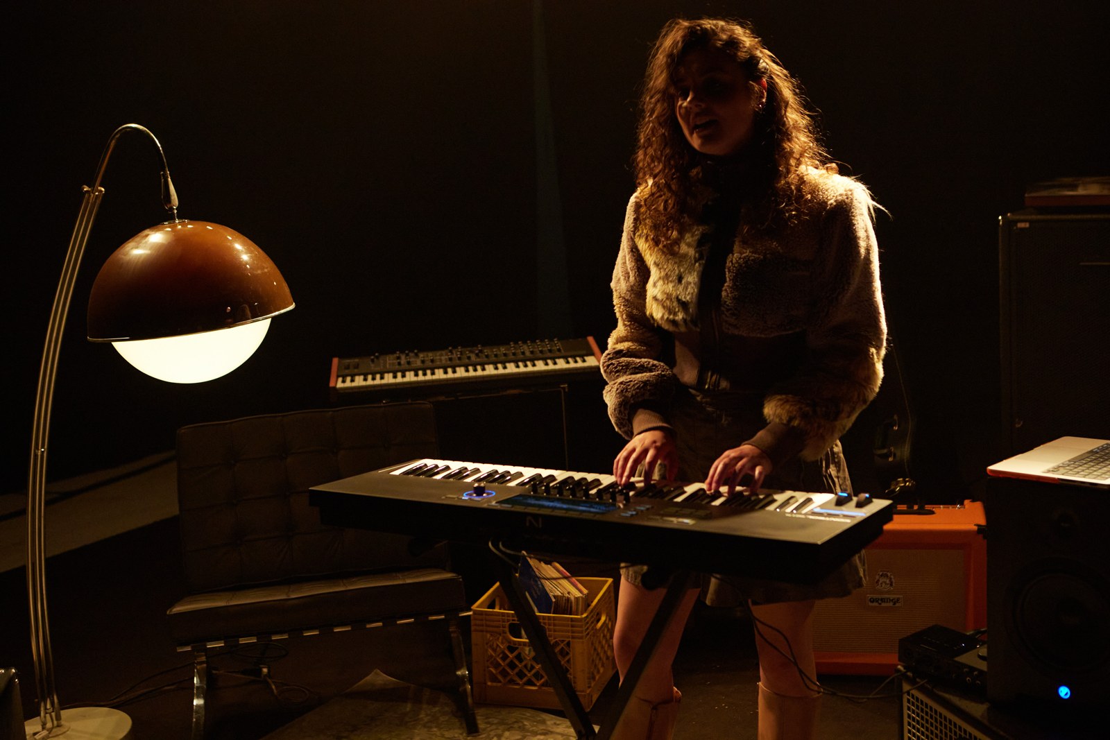 A player at a Native Instruments Kontrol S61 MK3 on a keyboard stand