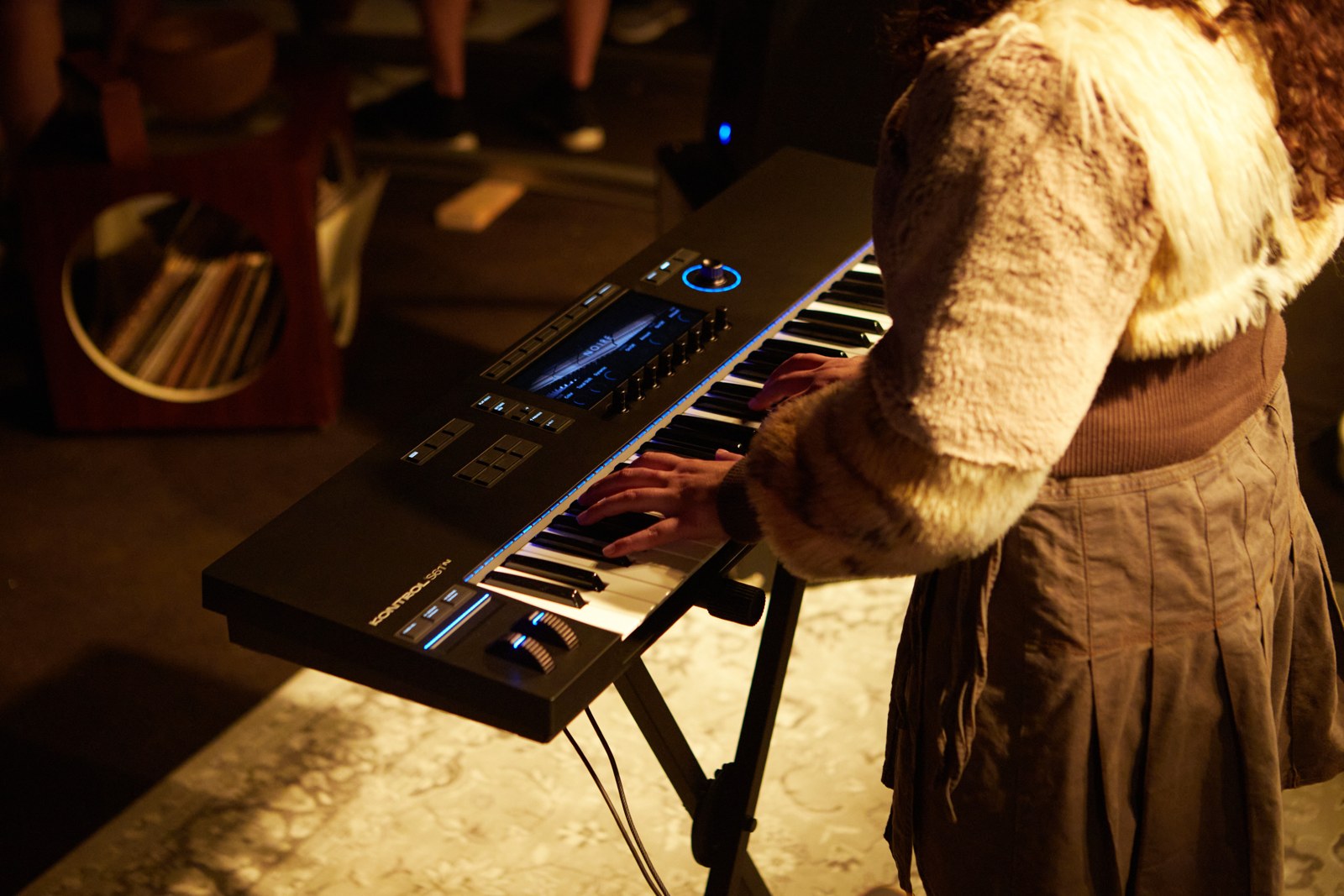 Native Instruments Kontrol S61 MK3 keyboard controller being played on a stand